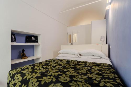 a small bedroom with a bed and white cabinets at Sole Mio in Sanremo