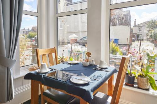 a dining room with a table and chairs and a window at The Tennyson in Bridlington