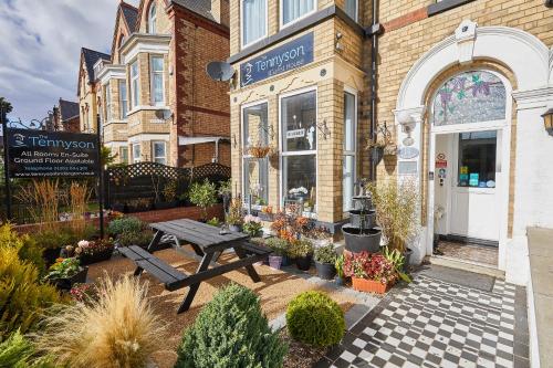a store with a picnic table outside of it at The Tennyson in Bridlington