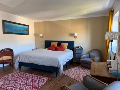 a bedroom with a bed and a couch and a chair at VILLA des Peintres in Étretat