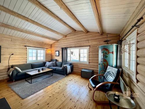 a living room with a couch and a table at Authentic mountain atmosphere at Sjusjøen in Ringsaker