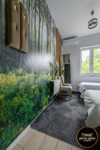 a bedroom with a wall mural of a forest at Hotel Leśny Korne koło Kościerzyny - Kaszuby in Korne