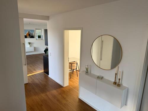 a white room with a mirror and a hallway at Seeblick Lünne Emsland in Lünne