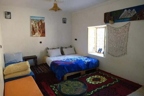 a small bedroom with a bed and a window at Chez youba in Azilal