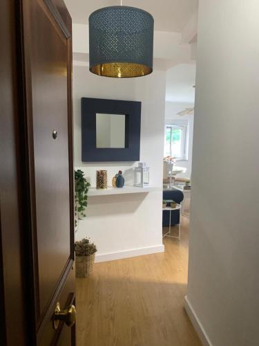 a hallway with a mirror and a door to a room at La ballena de rayas in Tazones