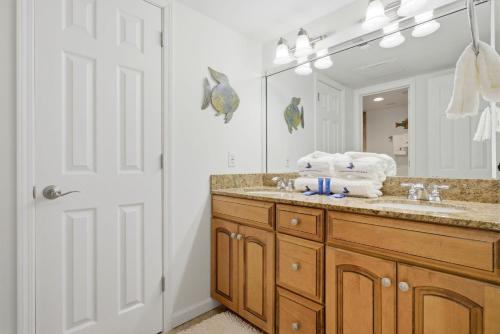 a bathroom with a sink and a mirror at SeaSpray Riverside 312 in Perdido Key