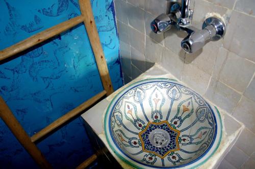 a blue and white toilet in a bathroom at Chez youba in Azilal