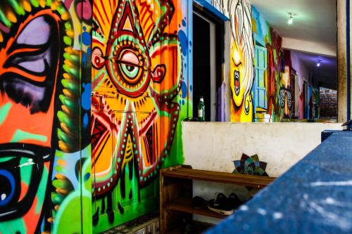 a room with a wall covered in colorful graffiti at Pappi Chulo Vagator in Vagator