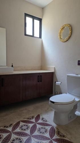 a bathroom with a toilet and a sink and a tub at Casa Ancestra in Santa Cruz