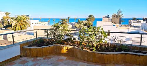 a balcony with a view of the ocean and buildings at Dar Essaada - Exceptionel duplex de 270 M2, plage à 2 min à pieds in Mahdia