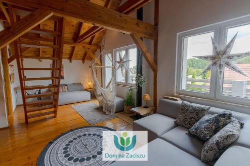 a living room with a couch and a staircase at Dom na Zaciszu Charzykowy in Charzykowy
