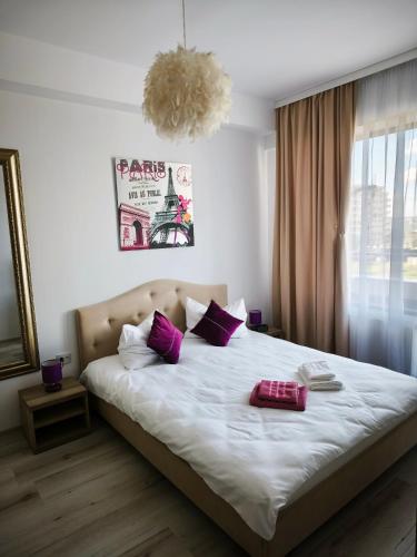 a bedroom with a large bed with purple pillows at SeaLaVie - Summerland Mamaia in Mamaia