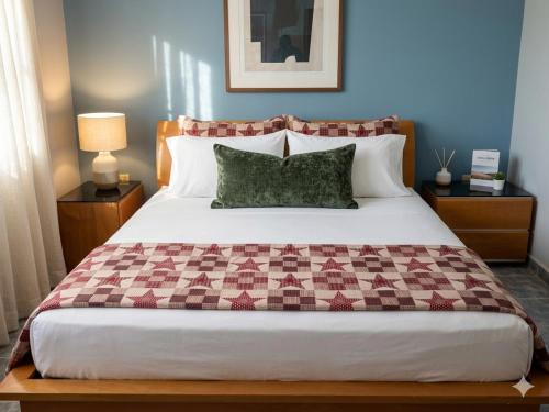 a bedroom with a large bed with a checkered blanket at Águila Marina Suites in Chichiriviche