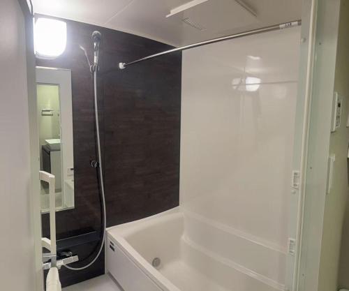 a bathroom with a shower and a white bath tub at Sumida Ward - Hotel - Vacation STAY 00237v in Tokyo