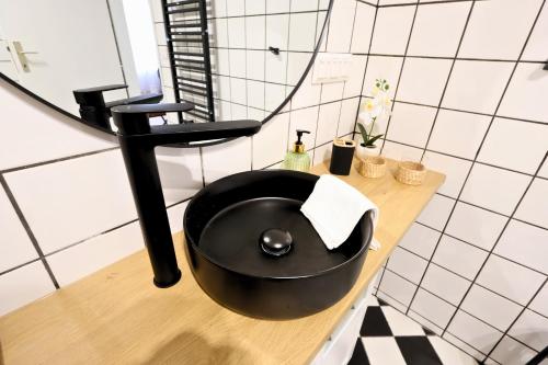 a bathroom with a black sink and a mirror at St Antoni Suite 4 in Eisenstadt