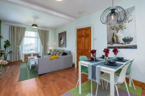 a living room with a table and a couch at 3BDR Town House in the Heart of Holyhead - Free Onsite Parking in Holyhead