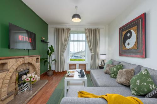 a living room with a couch and a fireplace at 3BDR Town House in the Heart of Holyhead - Free Onsite Parking in Holyhead