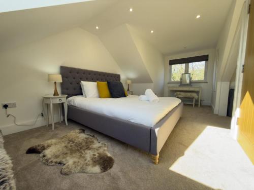 a bedroom with a bed with a dog laying on the floor at Beautiful River View with Sauna in Llandysul