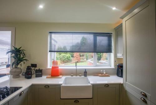 a kitchen with a sink and a window at Unique 3 Bed Home, Stewarton in Stewarton
