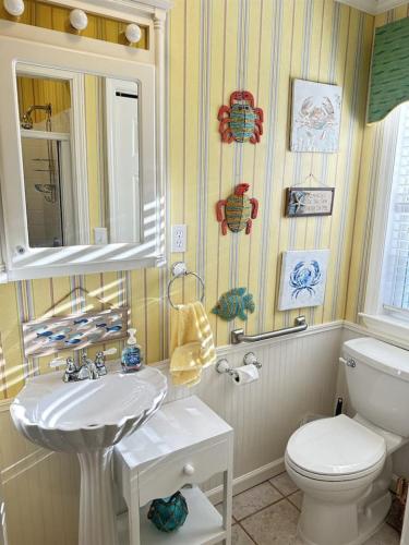 a bathroom with a white sink and a toilet at Just Peachy in Myrtle Beach