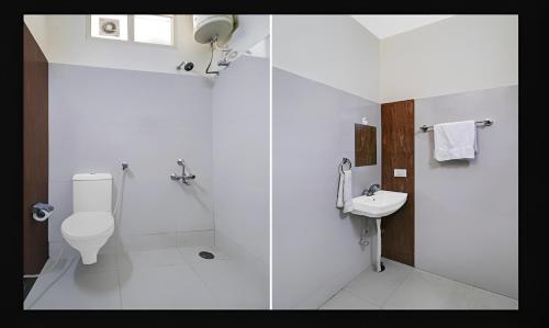 a white bathroom with a toilet and a sink at Hotel Starwood Near Airport Road Sector 78 Mohali Chandigarh in Mohali