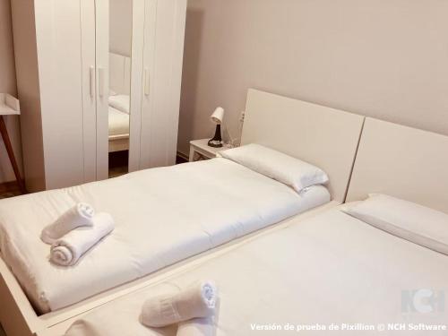 a bedroom with two beds and a mirror at San Gregorio 2 in Soria
