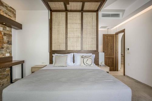 a bedroom with a large bed with two pillows at Aurora Thesan in Marathias