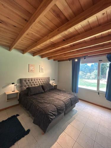 a bedroom with a large bed and a large window at Seamount Design in Mar del Plata