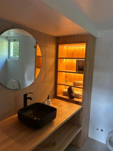 a bathroom with a black sink and a mirror at Seamount Design in Mar del Plata