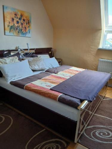 a bedroom with a bed with a blanket on it at Landhotel Eisdorf in Eisdorf