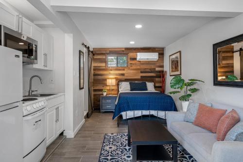 a bedroom with a bed and a couch and a kitchen at Downtown Vibes Stylish Studio, Perfect Location in Tampa