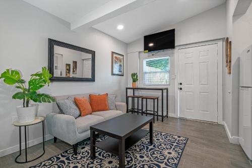 a living room with a couch and a table at Downtown Vibes Stylish Studio, Perfect Location in Tampa