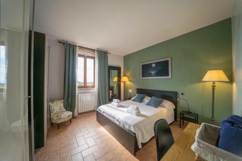 a hotel room with a bed and a chair at My Tuscany Suites in Castiglioncello