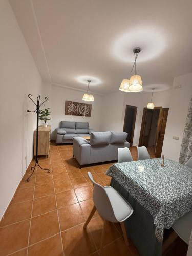a living room with a table and a couch at Alfarnate Antiguo Cuartel in Alfarnate
