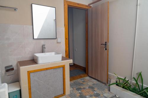 a bathroom with a sink and a mirror at Ayvana Retreat in Feridhoo