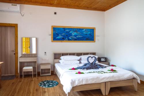 a bedroom with a bed with an octopus on it at Ayvana Retreat in Feridhoo