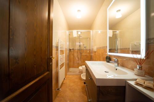 a bathroom with a sink and a shower and a toilet at My Tuscany Suites in Castiglioncello