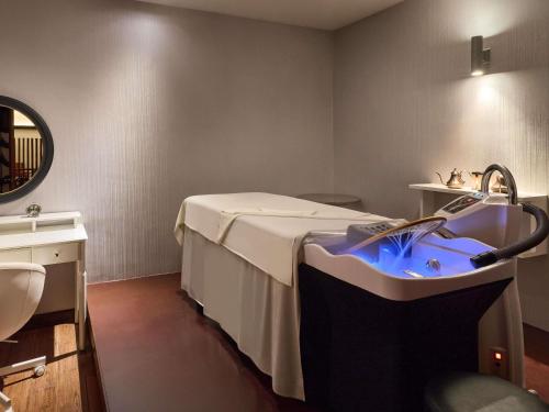 a hospital room with a bed and a sink at Novotel Phuket Vintage Park Resort in Patong Beach