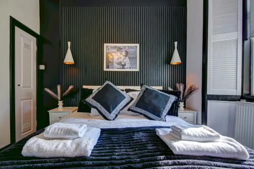 a bedroom with a bed with two pillows on it at Tiffanys Boutique - Coorie Doon Stays in Prestwick