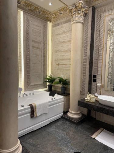 a large bathroom with a tub and a sink at Arizona 2 in Islamabad