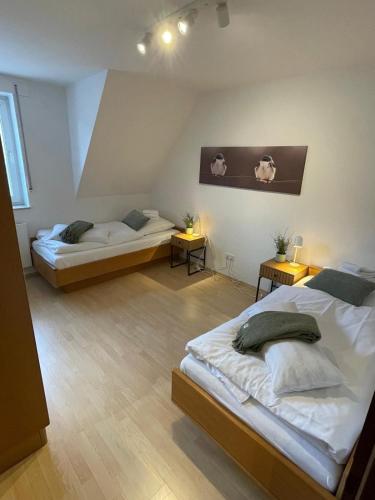 a bedroom with two beds and two night stands at Fewo Auenblick in Ascheberg