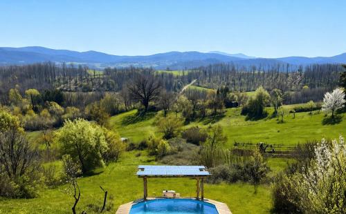 a house with a swimming pool in a field at Casa Eleonora in Chiusdino