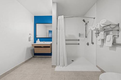 a bathroom with a shower and a sink at Spark by Hilton Pelham Birmingham I 65 in Pelham