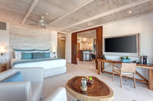 a bedroom with a bed and a living room at Mystique Holbox by Royalton, A Tribute Portfolio Resort in Holbox Island