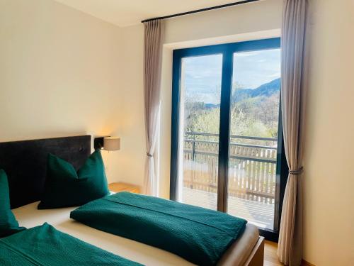 a bedroom with a bed and a large window at Unterlechnerhof in Vollan