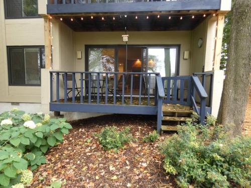 a porch of a house with a blue railing at Courtside Condo at Summit in Bellaire