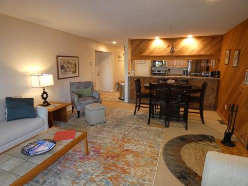 a living room with a couch and a table at Courtside Condo at Summit in Bellaire