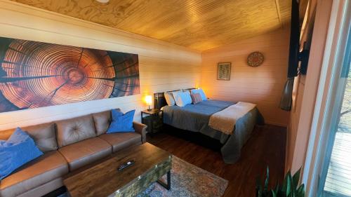 a bedroom with a bed and a couch in a room at Bison Farm - Cabin "Vista" in Culpeper