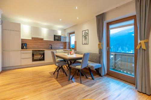 a kitchen and dining room with a table and chairs at Haus Dorfblick in Filzmoos