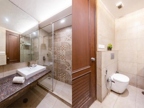 a bathroom with a toilet and a sink and a shower at Hotel The Imperio, Near Apollo Hospital, JASOLA in New Delhi